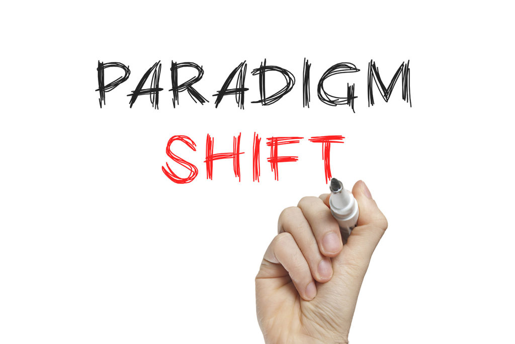  A hand holding a marker and underlining the word 'shift' in large text that reads 'paradigm shift'.